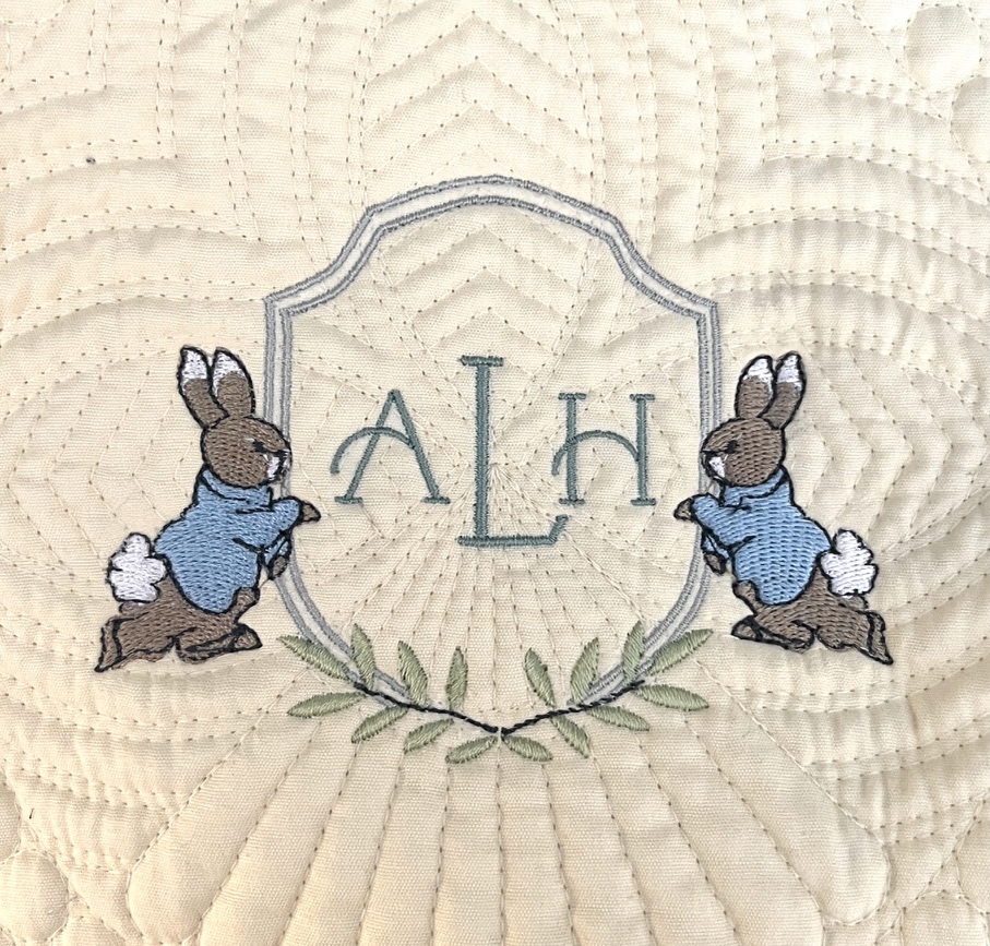 Yellow baby blanket with cottontail rabbits and monogram embroidery