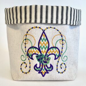 Off-white canvas basket embroidered with gold, purple and green fleur de lis beads