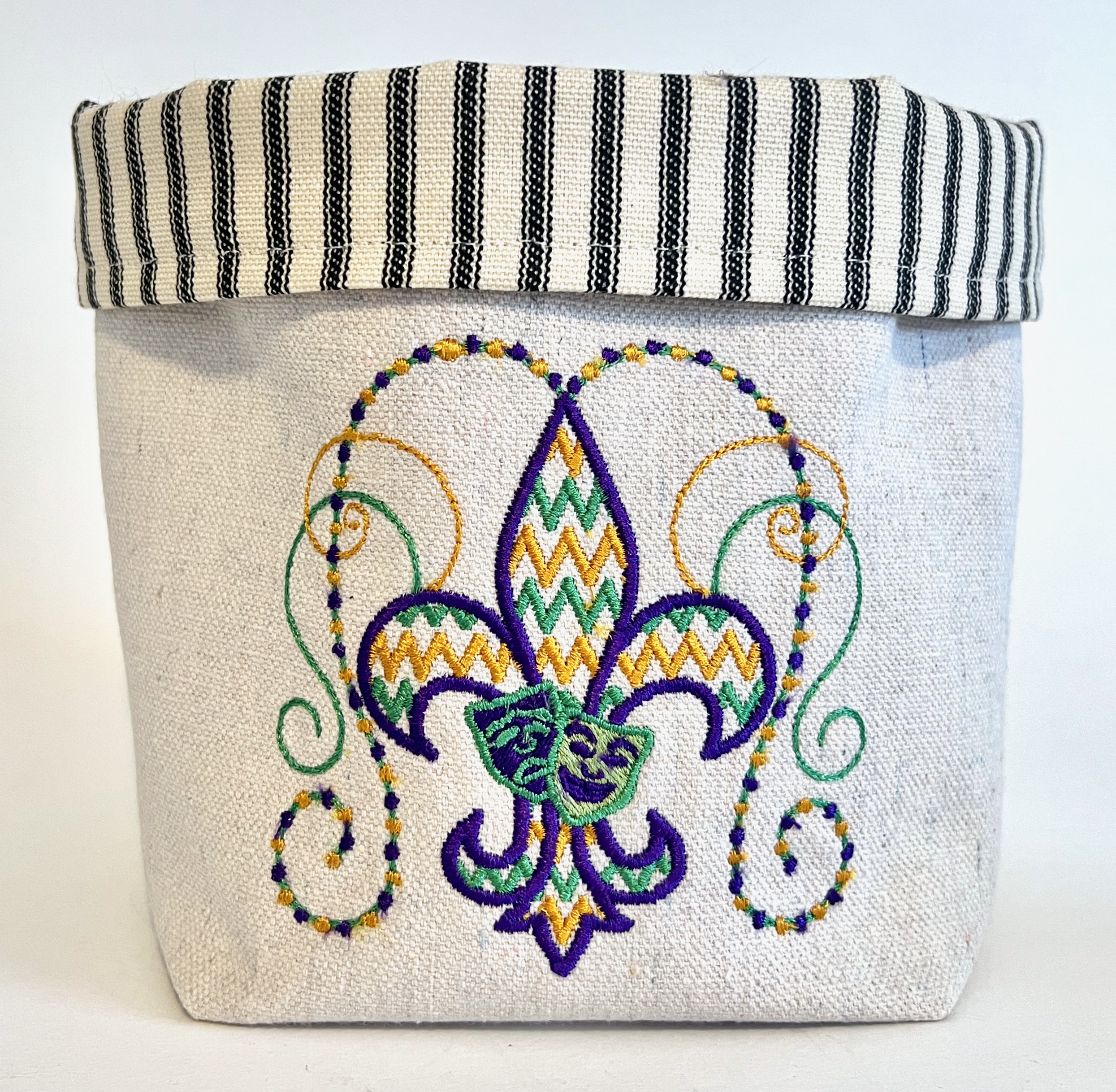 Off-white canvas basket embroidered with gold, purple and green fleur de lis beads